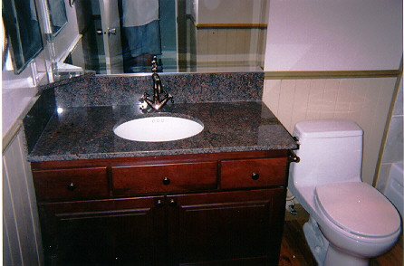 Beautiful Cherry Wood Vanity with Granite Countertop. Wainscoting and Crown Molding.